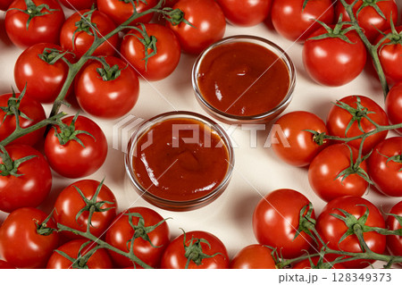 Glass Bowls of Ketchup Surrounded by Fresh Tomatoes. Homemade Sauce Concept. 128349373
