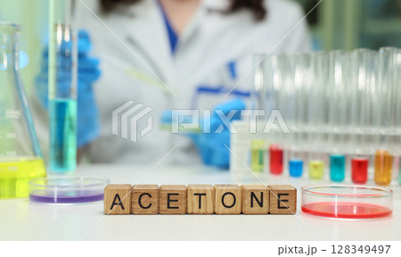 Conducting a detailed lab experiment with acetone and colorful solutions for analysis Conducting a detailed lab experiment with acetone and colorful solutions for analysis 128349497