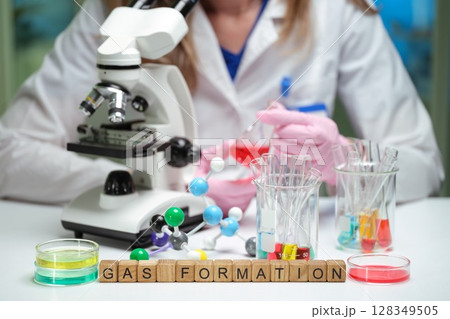 Conducting a lab experiment on gas formation using a microscope to observe reactions Conducting a lab experiment on gas formation using a microscope to observe reactions 128349505