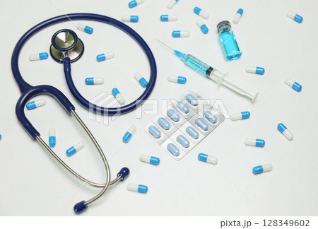 Essential tools in healthcare include a stethoscope, a syringe, and various types of medicine Essential tools in healthcare include a stethoscope, a syringe, and various types of medicine 128349602