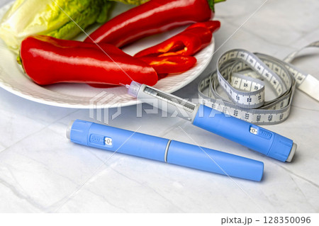 Original Danish Ozempic Insulin injection pen for diabetics and plate with vegetables. 128350096