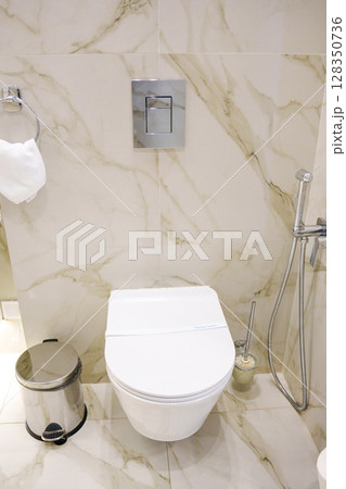 a paper strip with the inscription Sanitary safety on the toilet.  128350736