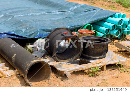 Collection of plumbing materials like pipes fittings is displayed at construction site under works day 128351449