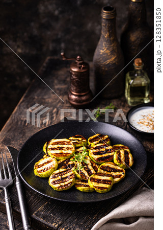 Grilled zucchini with sauce, vegan dish Grilled zucchini with sauce, vegan dish 128351850