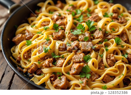 Gourmet pasta dish with savory beef stew, garnished with herbs. 128352386