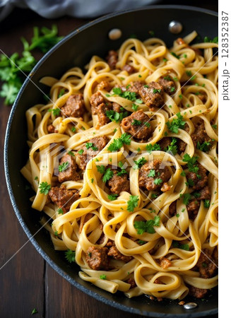 Gourmet pasta dish with savory beef stew, garnished with herbs. 128352387