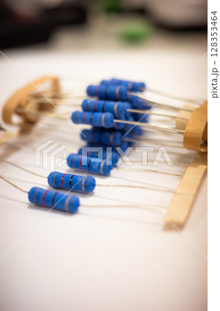 Close Up of Blue Electronic Resistors on White Surface 128353464