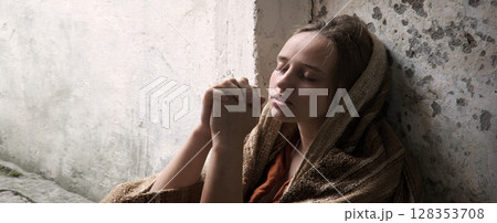 Poor young girl prayint to God 128353708