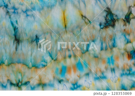 abstract pattern on silk fabric texture in blue, yellow, green colors 128353869