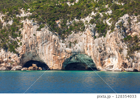 Grotta del Bue Marino sea caves in limestone cliffs on the eastern Sardinian coast with turquoise Mediterranean water Grotta del Bue Marino sea caves in limestone cliffs on the eastern Sardinian coast with turquoise Mediterranean water 128354033