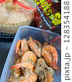 Savory cooked shrimp in a plastic food container, a tasty meal. 128354188