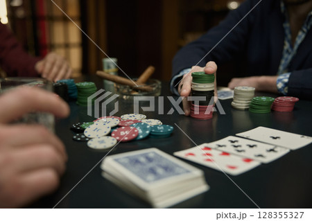 An intense poker game featuring chips, thrilling and excitement An intense poker game featuring chips, thrilling and excitement 128355327