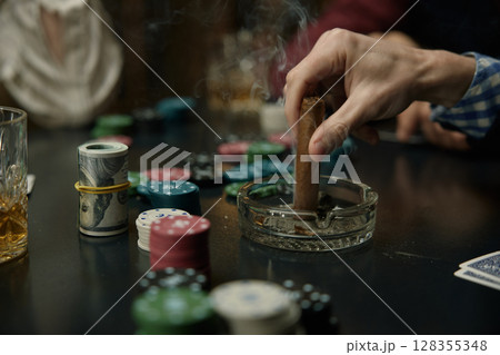 Man Putting Out Cigar During Intense Poker Game Man Putting Out Cigar During Intense Poker Game 128355348