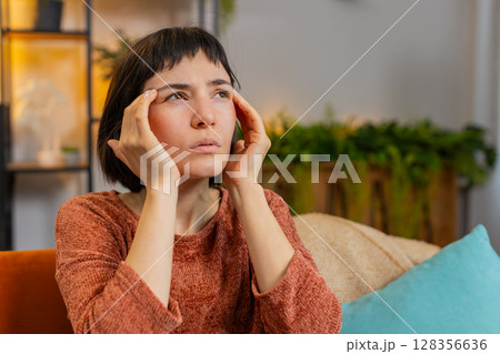 Woman rubbing temples to cure headache problem suffering from tension and migraine stress pain Woman rubbing temples to cure headache problem suffering from tension and migraine stress pain 128356636