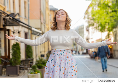 Redhead woman taking a deep breath of fresh air relaxing taking a break resting meditating outdoor 128356639