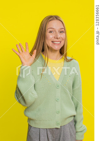 Happy woman smiling friendly waving hands gesturing hello greeting or goodbye, meeting invitation Happy woman smiling friendly waving hands gesturing hello greeting or goodbye, meeting invitation 128356661