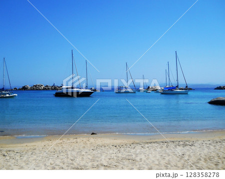 Crystal-Clear Waters and Yachts off Lavezzi Island, Corsica. This breathtaking aerial or coastal view captures the idyllic beauty of Lavezzi Island, nestled in the Strait of Bonifacio between Corsica 128358278