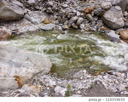 Mountain Stream with Clear Water Flowing Over Rocks Mountain Stream with Clear Water Flowing Over Rocks 128359650