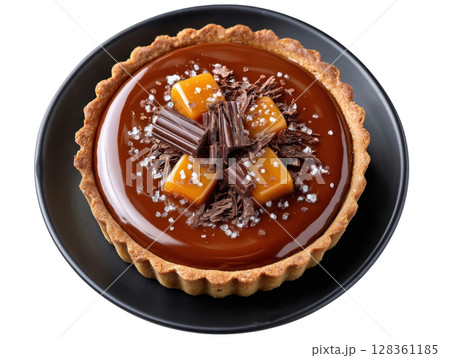 Glossy Chocolate Tart with Sea Salt Caramel Filling and Chocolate Shavings on a Dark Plate 128361185