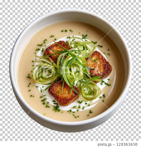 Creamy Leek and Potato Veloute Soup with Crispy Leek Threads and Sour Cream Quenelle in Shallow Bowl 128361630