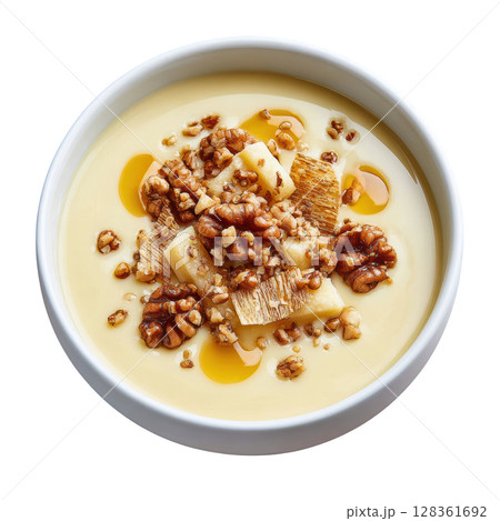Creamy Parsnip Soup in Shallow Bowl with Crisps, Hazelnut Oil, and Toasted Seeds for a Gourmet Presentation Creamy Parsnip Soup in Shallow Bowl with Crisps, Hazelnut Oil, and Toasted Seeds for a Gourmet Presentation 128361692