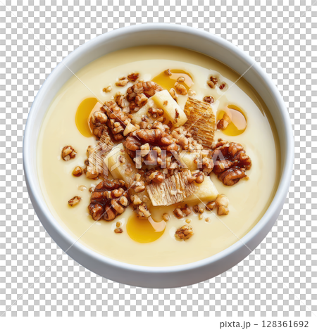 Creamy Parsnip Soup in Shallow Bowl with Crisps, Hazelnut Oil, and Toasted Seeds for a Gourmet Presentation Creamy Parsnip Soup in Shallow Bowl with Crisps, Hazelnut Oil, and Toasted Seeds for a Gourmet Presentation 128361692