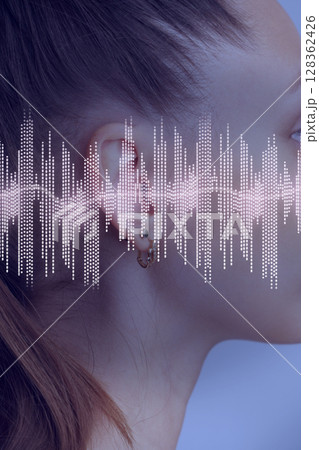 Sound wave visualization overlaid on the side profile of a woman with a ponytail in a serene setting Sound wave visualization overlaid on the side profile of a woman with a ponytail in a serene setting 128362426