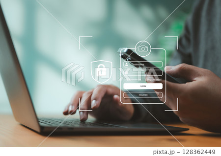 Close-up of two-factor authentication login screen on mobile and laptop. Concept of user security, identity verification, and online business access protection. Close-up of two-factor authentication login screen on mobile and laptop. Concept of user security, identity verification, and online business access protection. 128362449
