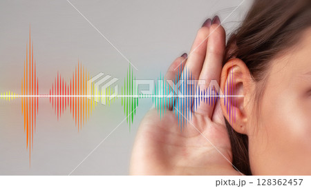 Listening to sounds and frequencies with waves in various colors at a studio setting 128362457