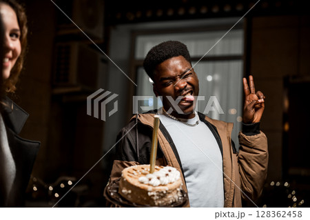 Celebration of friendship with cake at night gathering in urban setting 128362458