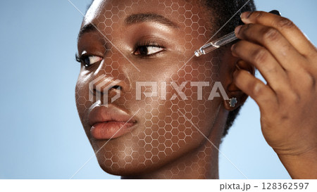 Skincare routine featuring serum application on model's face with a hexagonal pattern overlay during a beauty session 128362597