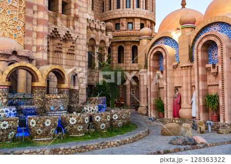 Architecture showcases intricate designs in a historic courtyard featuring unique fountains and vibrant domes Architecture showcases intricate designs in a historic courtyard featuring unique fountains and vibrant domes 128363322