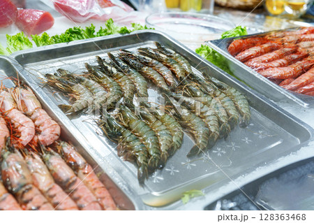 Fresh seafood displayed at a market stall during midday in a coastal town Fresh seafood displayed at a market stall during midday in a coastal town 128363468