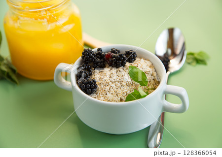 Bowl with dry cereal and berries on the background Bowl with dry cereal and berries on the background 128366054