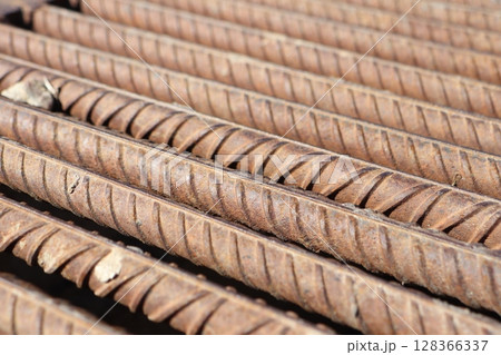 Detailed closeup image of reinforcement bars showcased in an industrial setting Detailed closeup image of reinforcement bars showcased in an industrial setting 128366337
