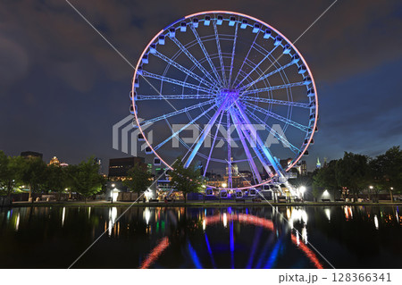 Montreal skyline illuminated with the famous wheel on the foreground at dusk Montreal skyline illuminated with the famous wheel on the foreground at dusk 128366341