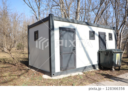 A modern utility shed designed to blend harmoniously into a natural setting or environment 128366356
