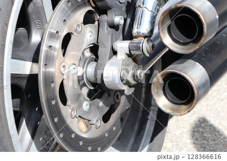 A Magnified CloseUp of a Motorcycle Wheel and Exhaust System With Intricate Details 128366616