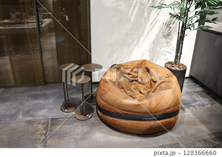 Inviting Cozy Contemporary Bean Bag accompanied by Modern Side Tables in a Stylish Setting 128366660
