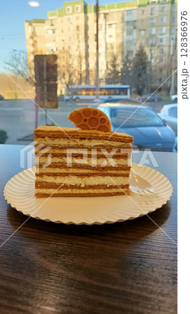 A Delicious Layered Cake Slice Beautifully Presented on a Plate for All to Enjoy 128366976