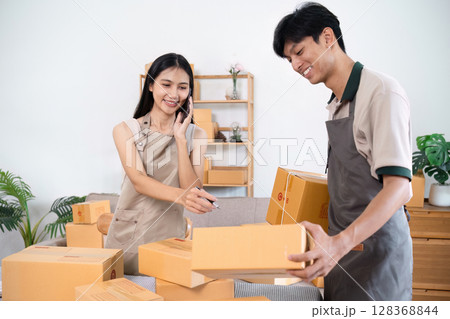 e-commerce business is writing a list of customers on paper, Business woman run an e-commerce business on website and social media. Selling product online e-commerce business is writing a list of customers on paper, Business woman run an e-commerce business on website and social media. Selling product online 128368844