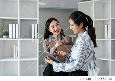 Professional Business women collaboration in Modern Office Environment with tablet and Documents 128369018