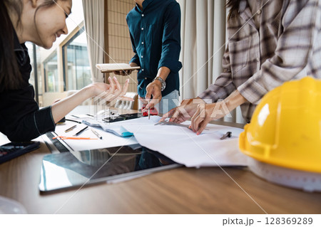 Team of Architect collaboration on Construction Project Plans in Modern Office Team of Architect collaboration on Construction Project Plans in Modern Office 128369289