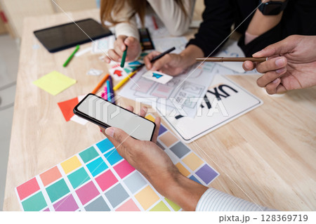 Creative UX UI Team Brainstorming for Startup Business Project with Colorful Design Elements and Prototypes 128369719