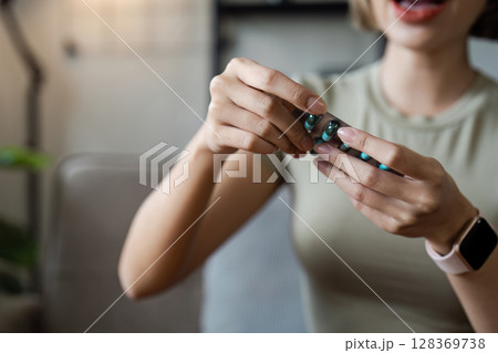 Woman Taking Medication at Home, Healthcare Concept with Pills and Modern Lifestyle Woman Taking Medication at Home, Healthcare Concept with Pills and Modern Lifestyle 128369738