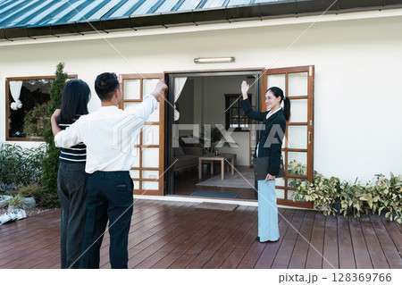 Real Estate Agent Showing and Present a New Home to Mature Couple 128369766