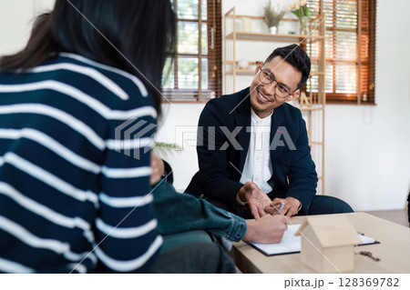 Real Estate Agent Smiling While lgbt lesbian Couple Client Signs Contract for New Home Purchase in Modern Office Setting Real Estate Agent Smiling While lgbt lesbian Couple Client Signs Contract for New Home Purchase in Modern Office Setting 128369782