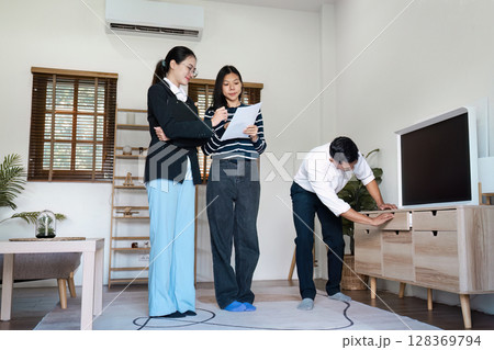 Real Estate Agent Showing Modern Apartment to Potential Client in Bright Living Room Real Estate Agent Showing Modern Apartment to Potential Client in Bright Living Room 128369794