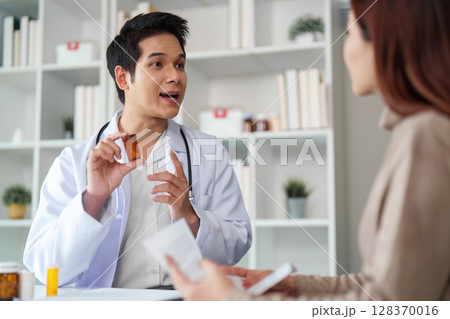 Doctor Explaining Medication to Patient in Consultation 128370016