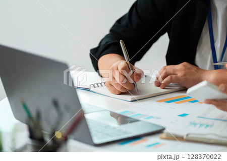 Business Collaboration. Professionals discussing financial data in a meeting. Business Collaboration. Professionals discussing financial data in a meeting. 128370022